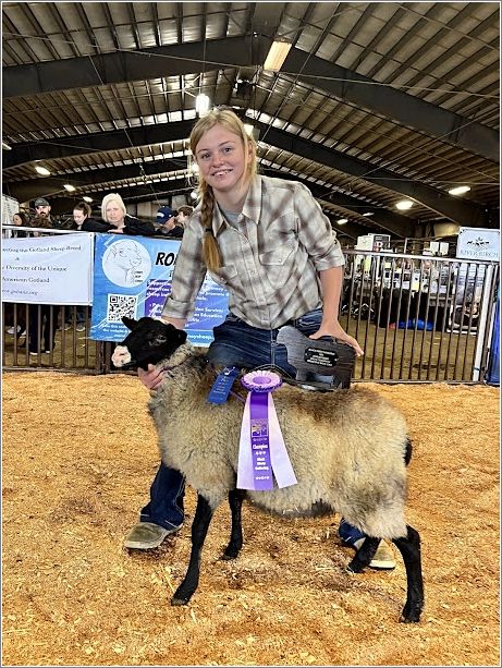 Kassidy Tiry with her champion primitive ram. Photo: Denali Bosco.